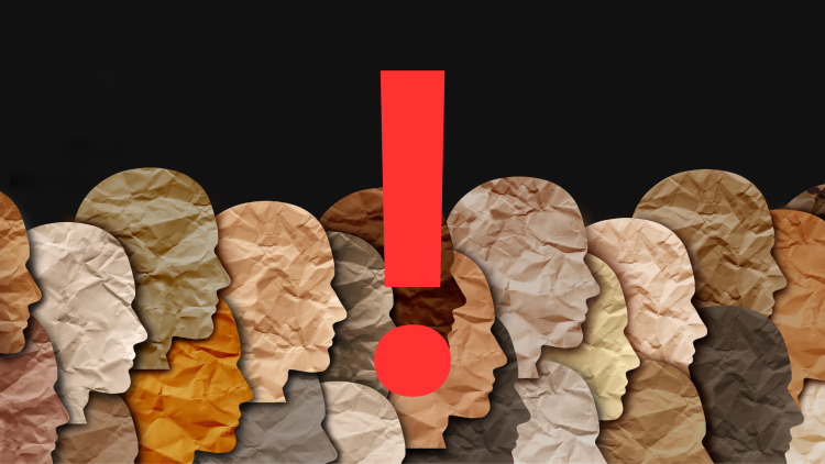 Wrapped paper cut outs in human shapes in different pastel brown shades. With a red explamation mark in the middle of the photo. Black background