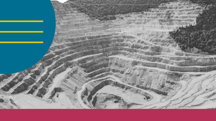 aerial view of an open-pit mine with terraced levels carved into the earth
